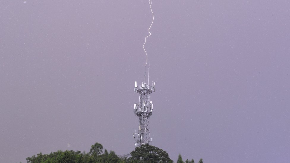 Lightning bolt hits a lightning rod on a communication base station in Renhuai city, Southwest China's Guizhou Province, Aug. 7, 2021