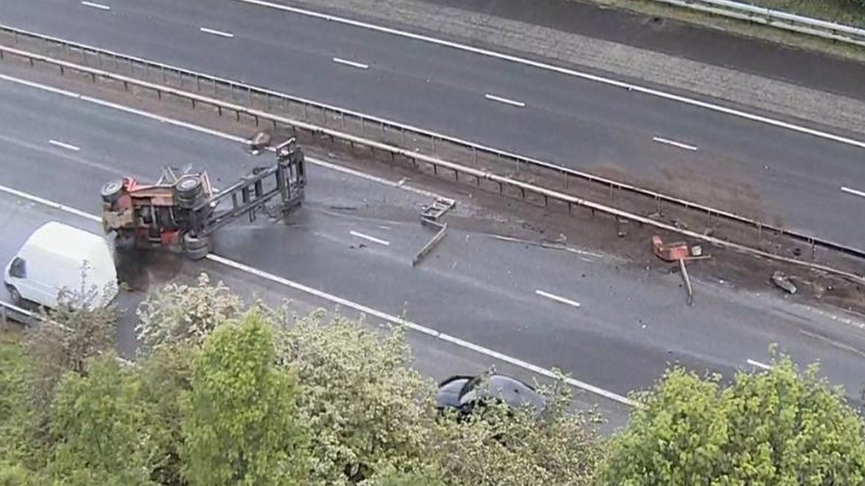 Major delays on M74 after forklift falls off lorry BBC News