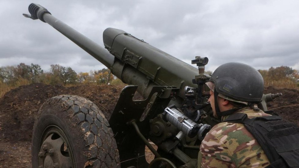 Member of the Ukrainian National Guard prepares a D-30 howitzer for a fire towards Russian troops in Kharkiv region