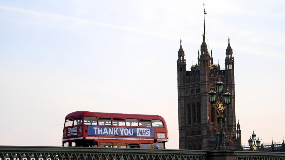 London bus drives past Big Ben