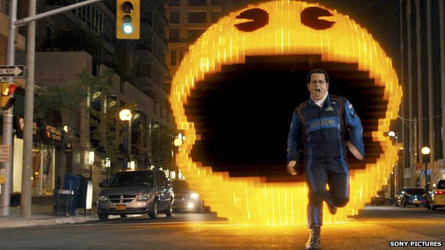 A scene from Pixels - a man is being chased by Pac Man