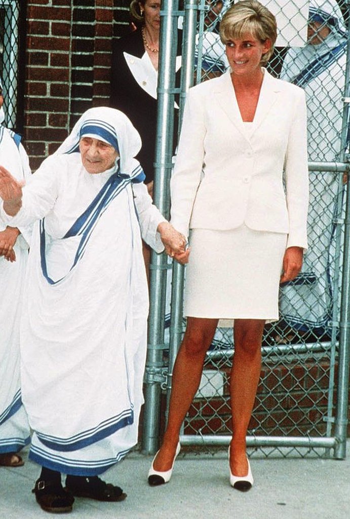 Diana, Princess of Wales, wearing a cream suit, holds hands with Mother Teresa following a meeting in the Bronx on June 18, 1997 in New York, NYC