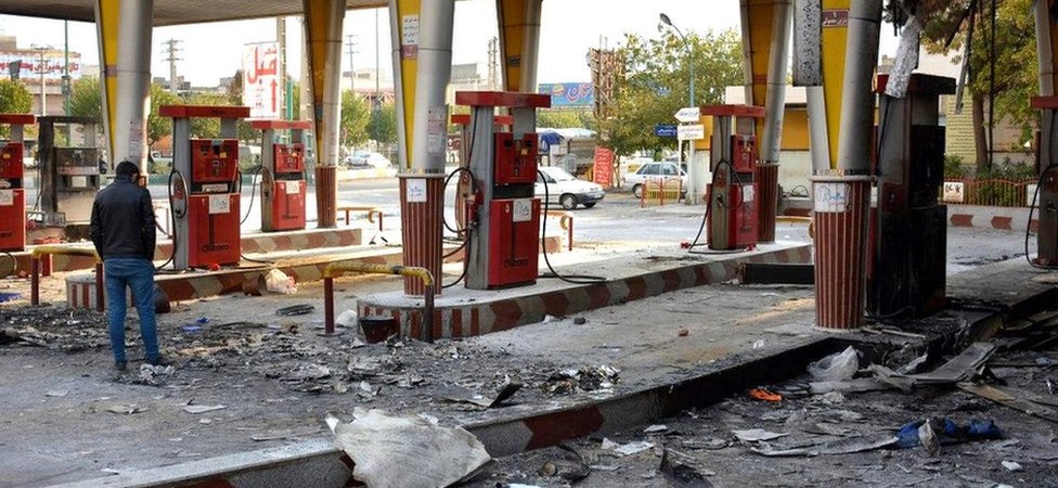 An Iranian man checks a scorched gas station that was set ablaze by protesters during a demonstration against a rise in gasoline prices in Eslamshahr, near the Iranian capital of Tehran, on November 17, 2019