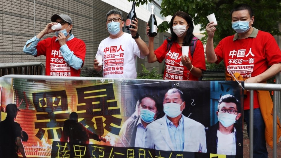 Pro-Beijing demonstrators celebrate the sentencings
