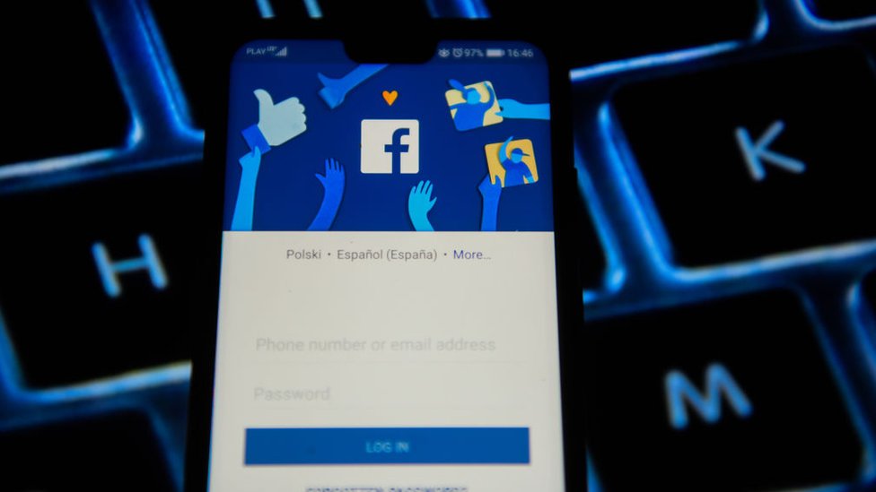 A phone displaying a Facebook login page