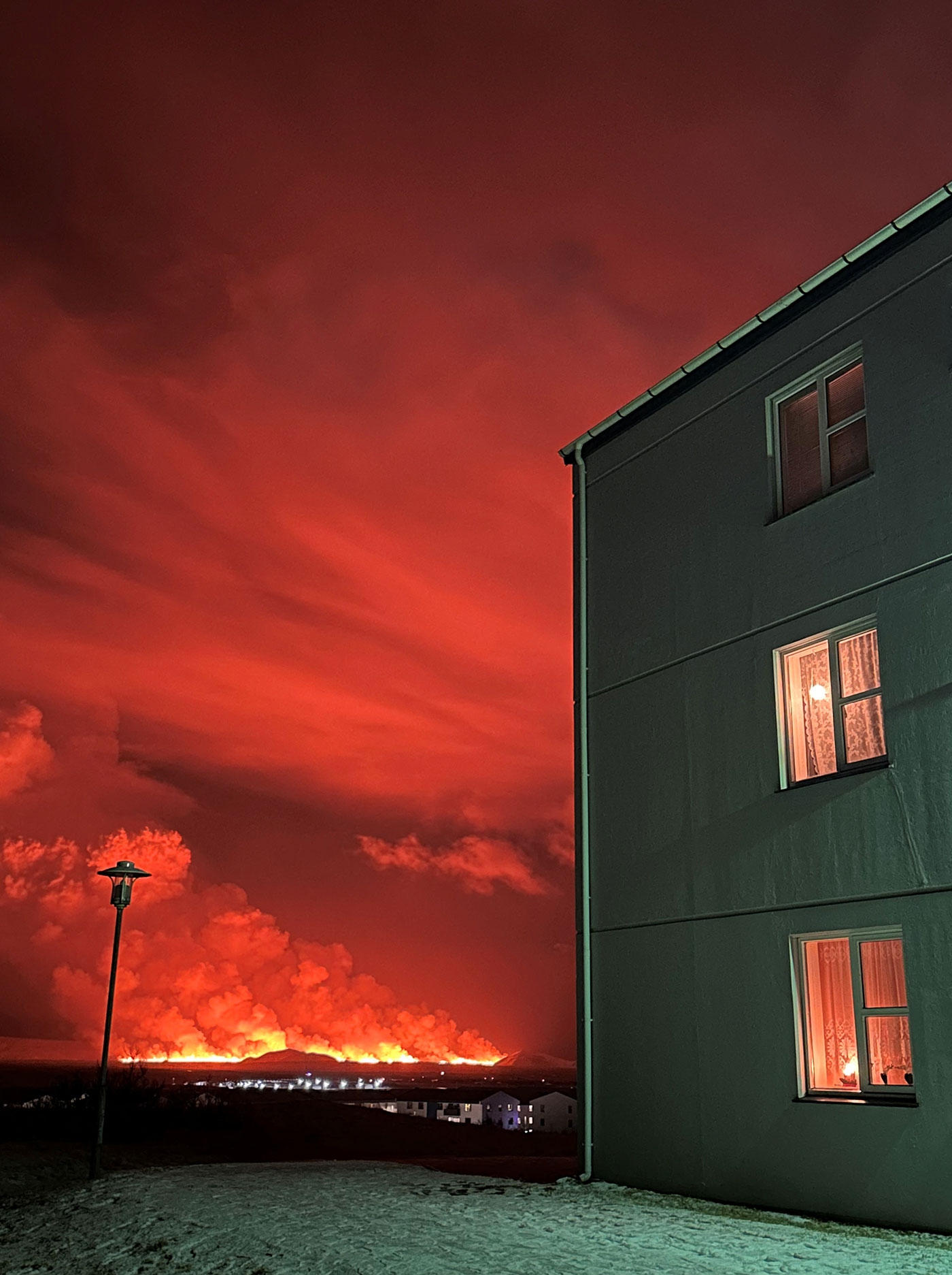 A view of the orange sky from the town of Keflavik, Iceland - 18 December 2023