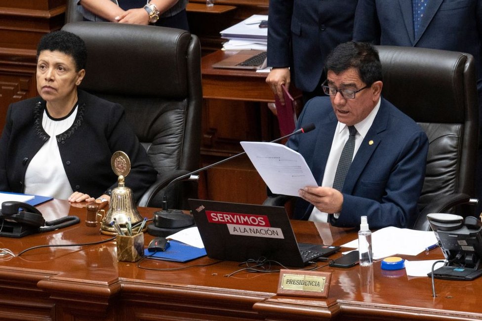 President of the Peruvian Congress Jose Williams Zapata (R) reads the vote result to impeach President Pedro Castillo during the plenary session in Lima on December 7, 2022. -