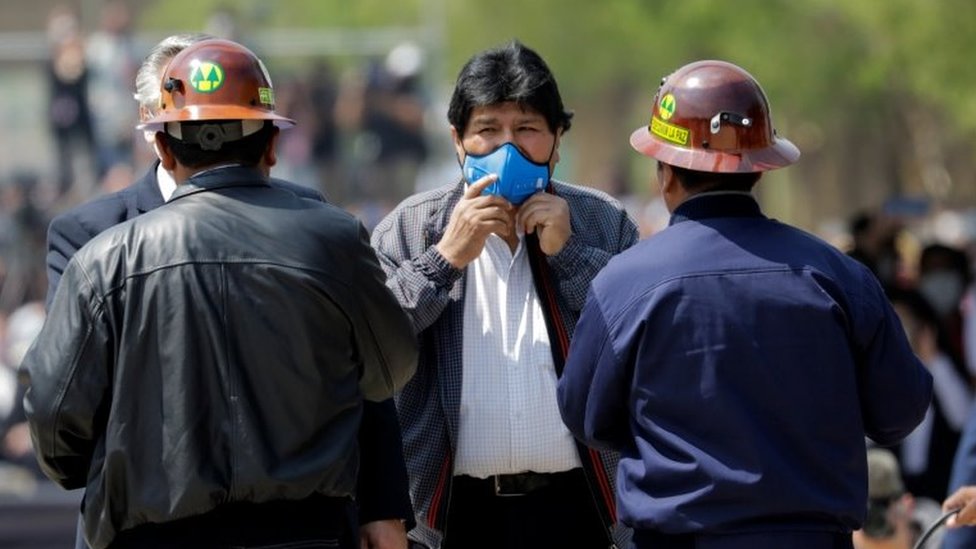 Бывший президент Боливии Эво Моралес держит маску на лице, когда он возвращается на родину из изгнания в Аргентине, в приграничном городе Виллазон, Боливия, 9 ноября 2020 года.