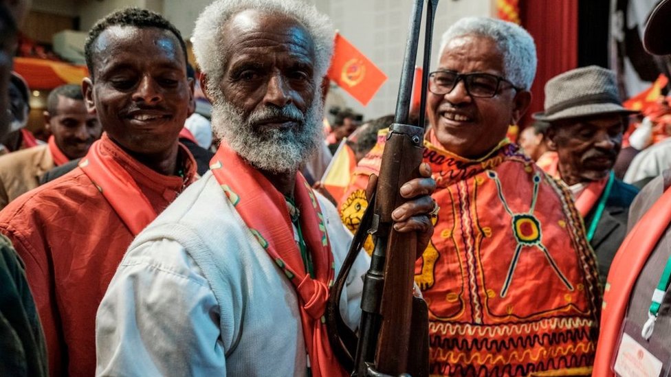 An attendee holds a rifle as people dance during the Tigray People's Liberation Front (TPLF) First Emergency General Congress in Mekelle, Ethiopia, on January 4, 2020