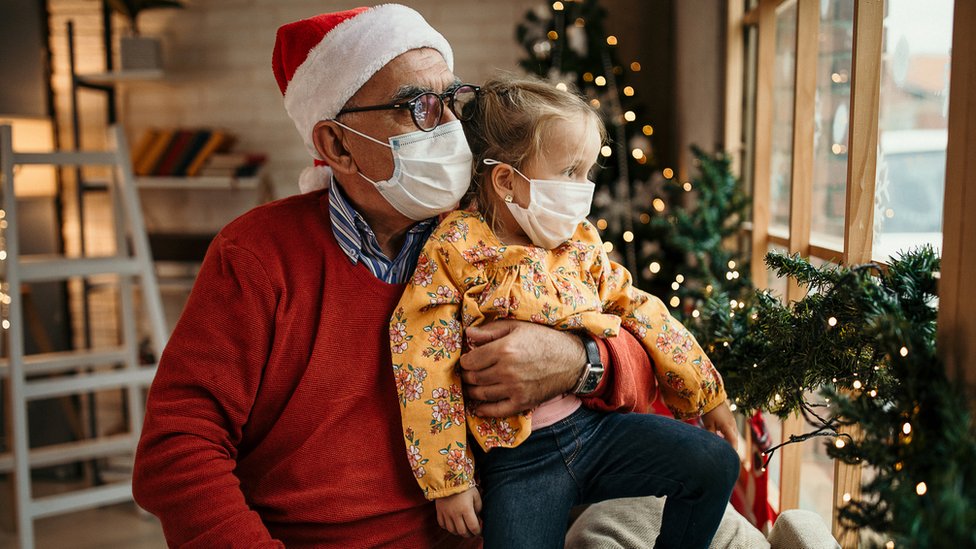 Grandfather sits with granddaughter during festive period