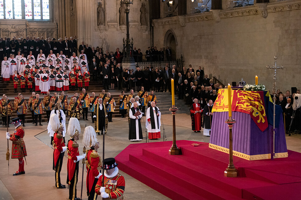 The Queen's coffin resting on a raised platform, known as a catafalque