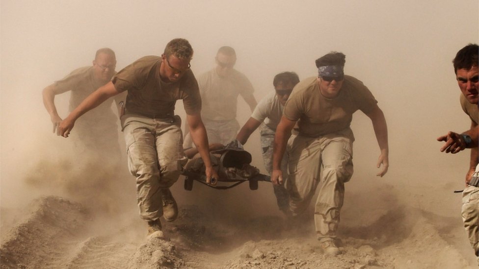 US troops pull a soldier to safety in Afghanistan, October 2010