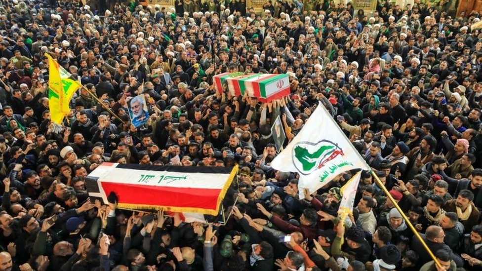 People mourn next to the coffins of slain Abu Mahdi al-Muhandis and Qassem Soleimani during a funeral procession in Najaf, Iraq, 04 January 2020