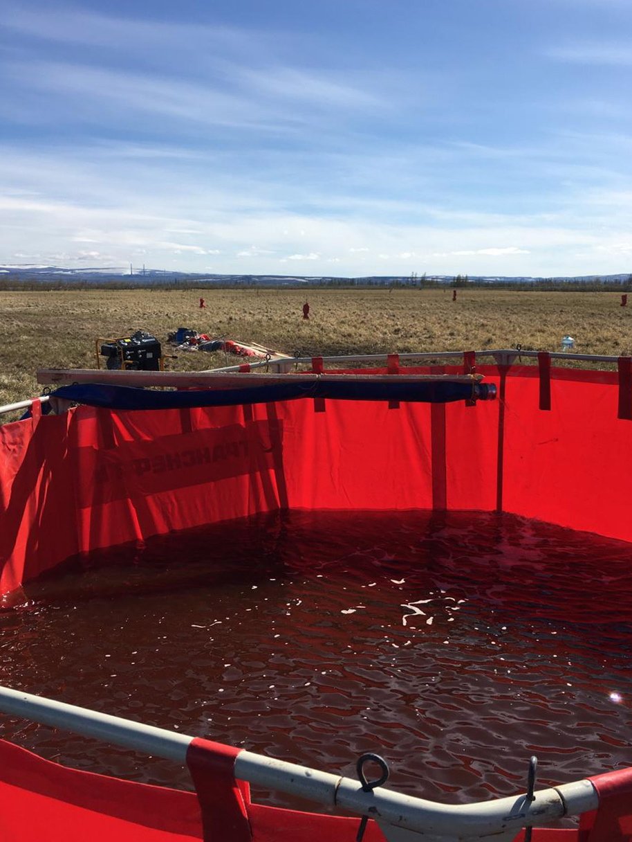 Oil and water pumped from the rivers inside a container