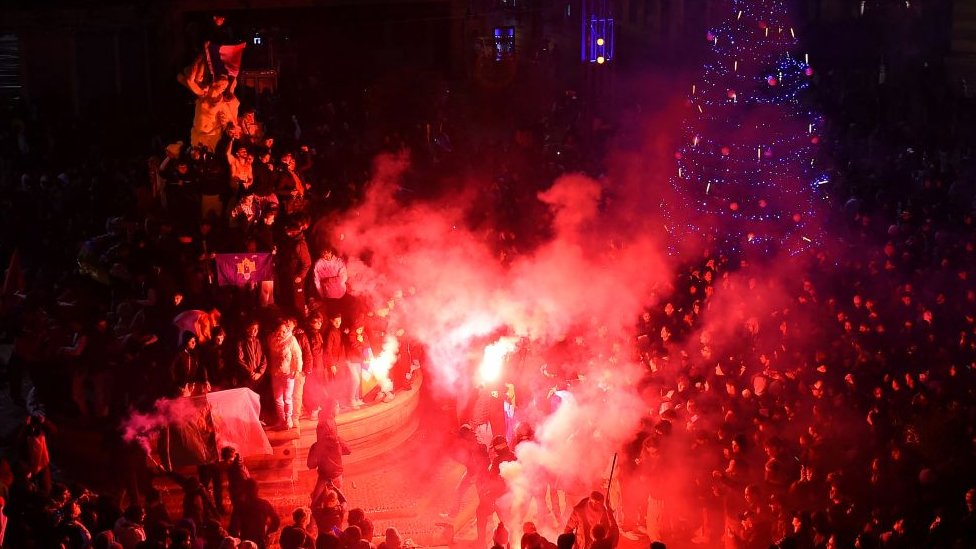 French supporters light flares as they celebrate their team's victory over England in the Qatar 2022 World Cup quarter-final football match in Montpellier on 10 December 2022