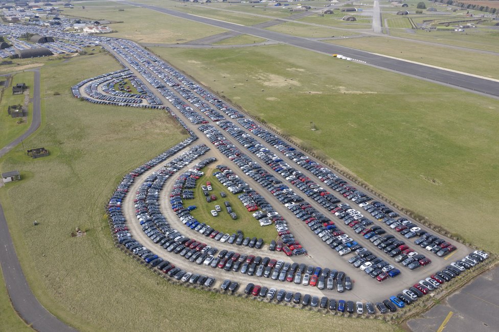 Aerial view of cars being stored on airport runways