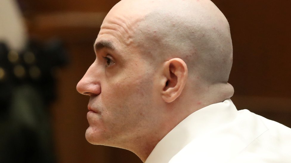 Michael Gargiulo, with a cleanly shaved bald head, is seen in a close-up profile in this court photo