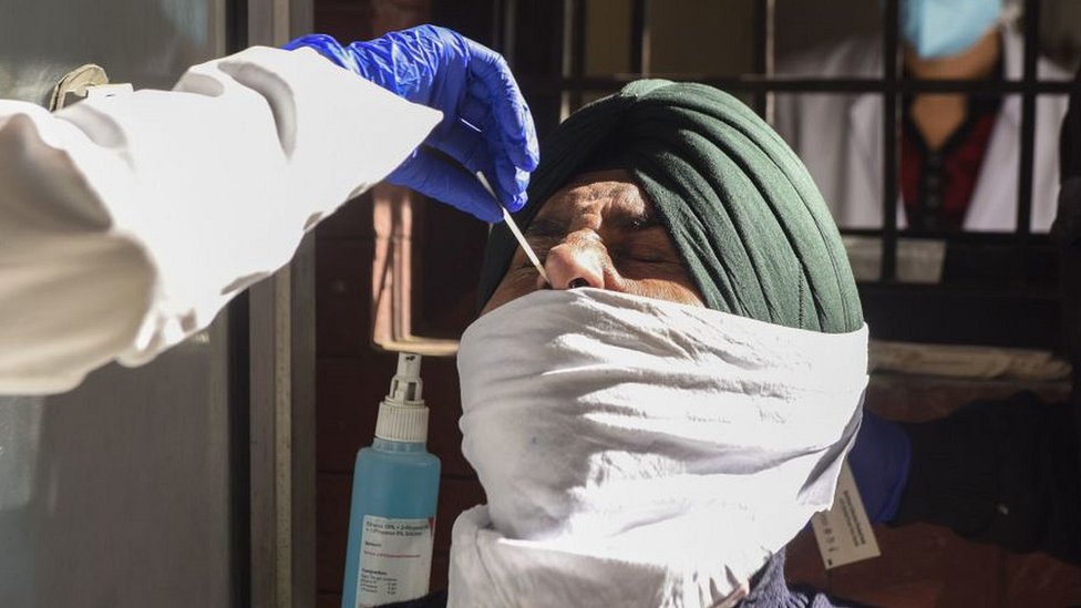 Man in Amritsar having nasal swab taken