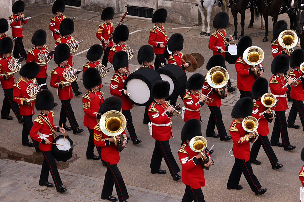 A military band play music as they march during the procession