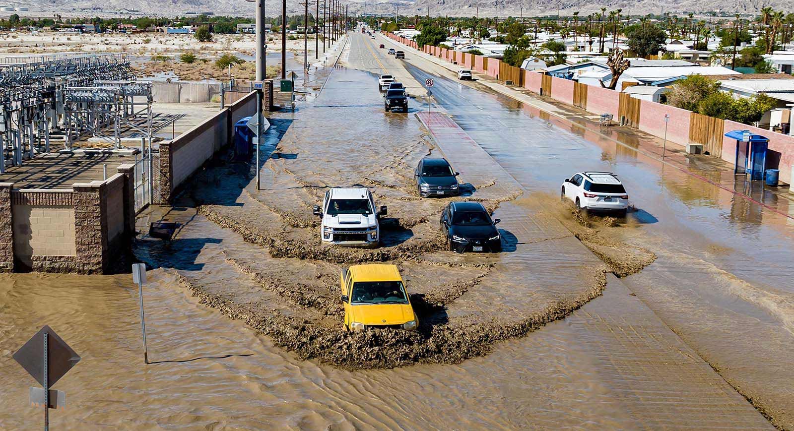 Aerial picture shows vehicles driving through floodwaters in Thousand Palms, California, following heavy rains from Tropical Storm Hilary - 21 August, 2023.