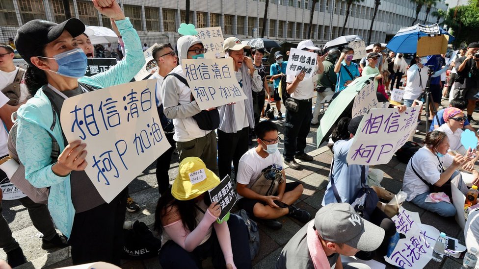 Supporters of former Taipei city mayor Ko Wen-je display placards and shout slogans outside Taipei city District Court, in Taipei, Taiwan, 31 August 2024.