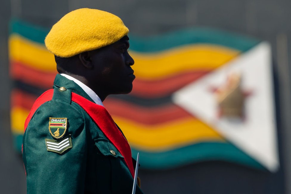 حارس يرتدي زيه العسكري الذي يتضمن ألوان علم بلده زيمبابوي.
