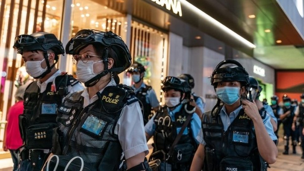 Riot police wearing protective masks patrol during a demonstration outside a shopping mall in Hong Kong