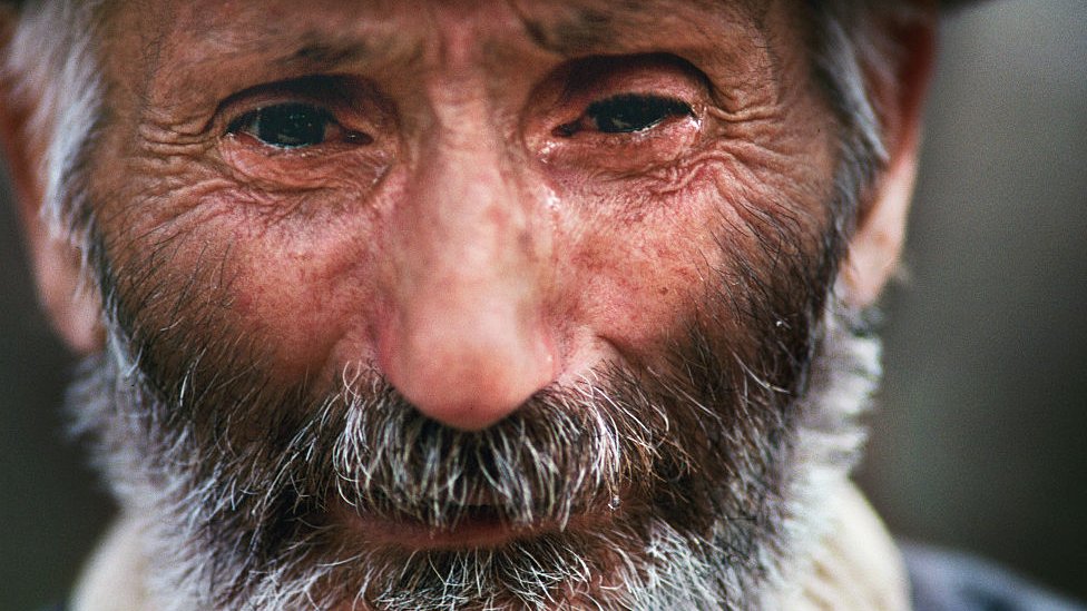 Man cries looking for his missing son after the Jóyali massacre in 1992.