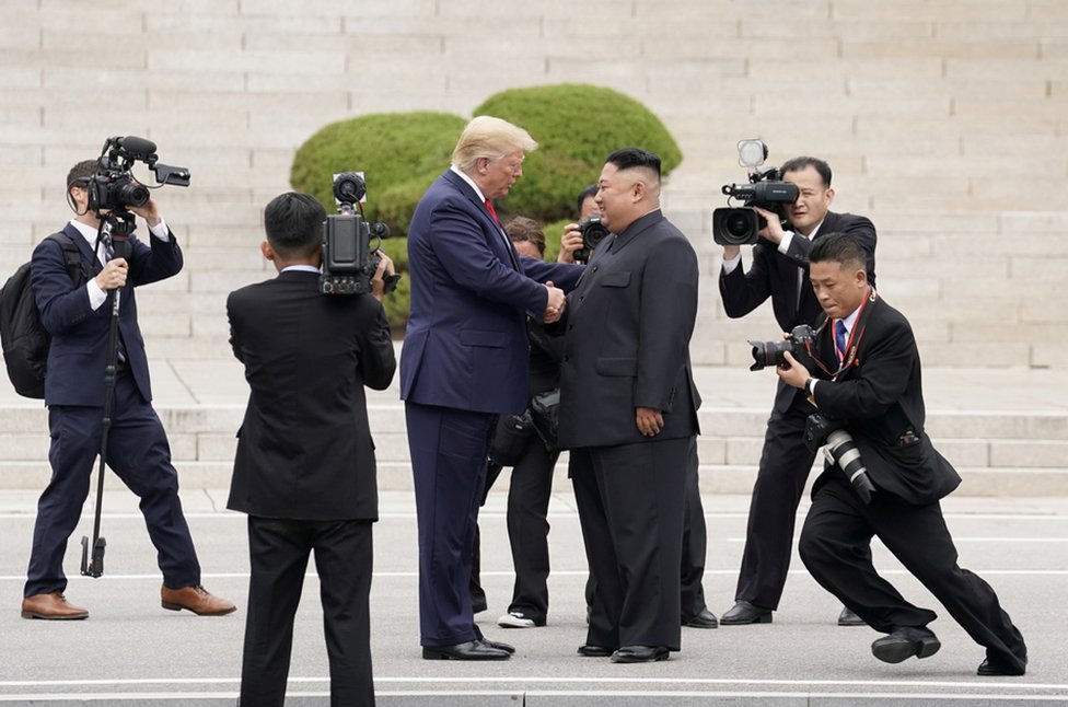 President Donald Trump meets with North Korean leader Kim Jong Un at the demilitarized zone separating the two Koreas, 30 June 2019.