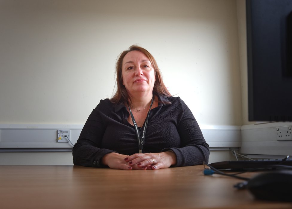 Michelle McHugh, the deputy bureau manager, sitting in front of a desk