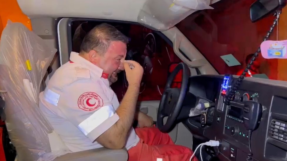 Paramedic Rami Khamis crying in driver's seat of ambulance