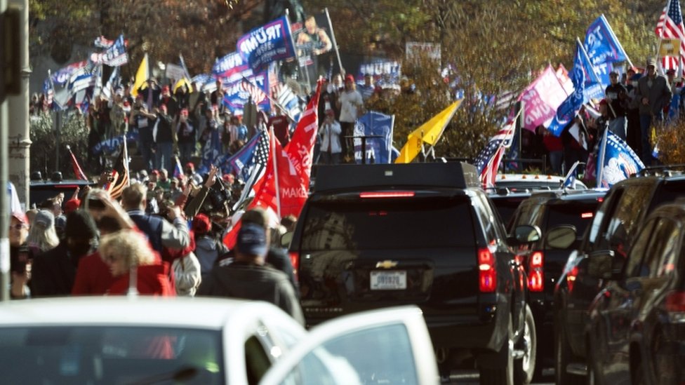 Trump supporters demonstrate as the motorcade carrying President Donald J. Trump drives through a rally of while departing the White House, headed out to an undisclosed location in Washington, DC, USA,