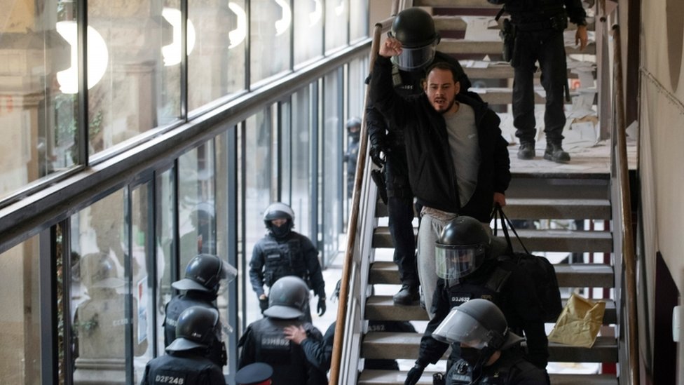 Spanish rapper Pablo Hasel reacts as he is detained by riot police inside the University of Lleida