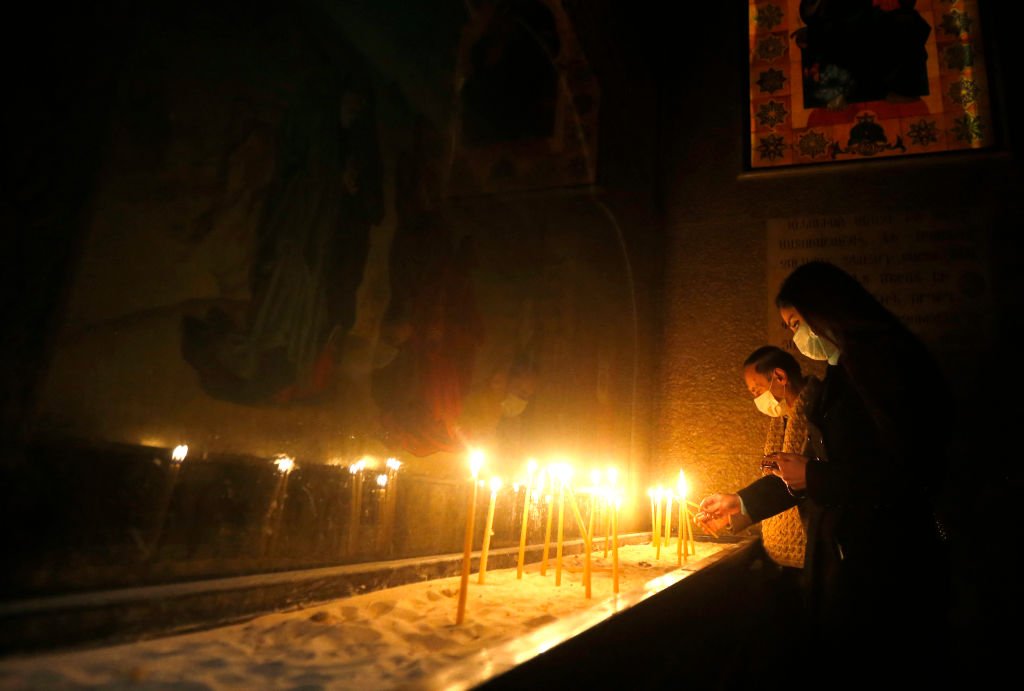 Syrian Christian worshippers light candles
