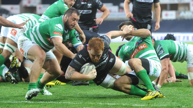 Dan Baker of the Ospreys scores his team's second try against Treviso