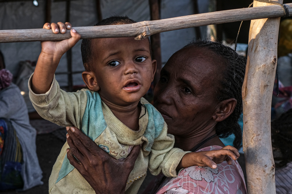 Refugees from the Tigray region of Ethiopia wait to be transferred to a camp