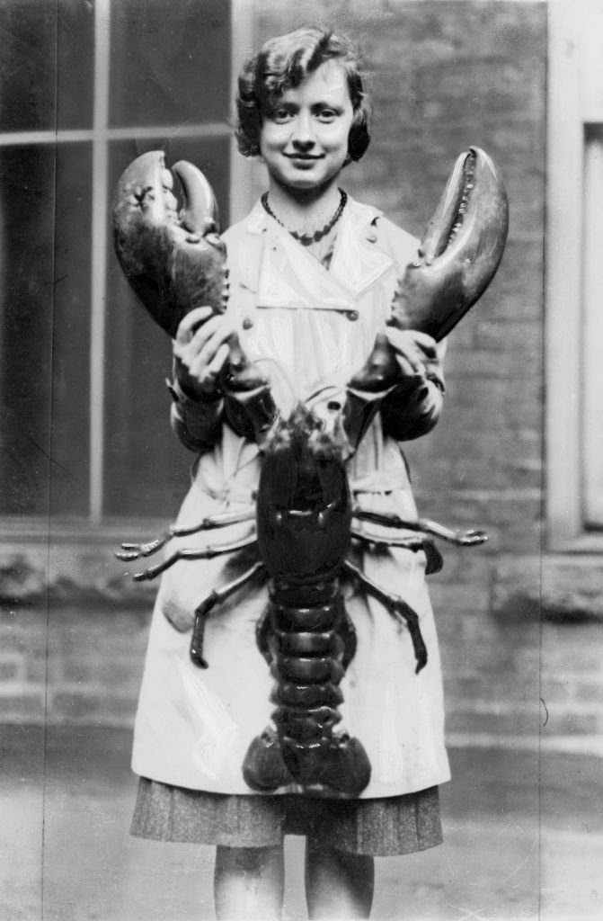 A girl holding a giant lobster