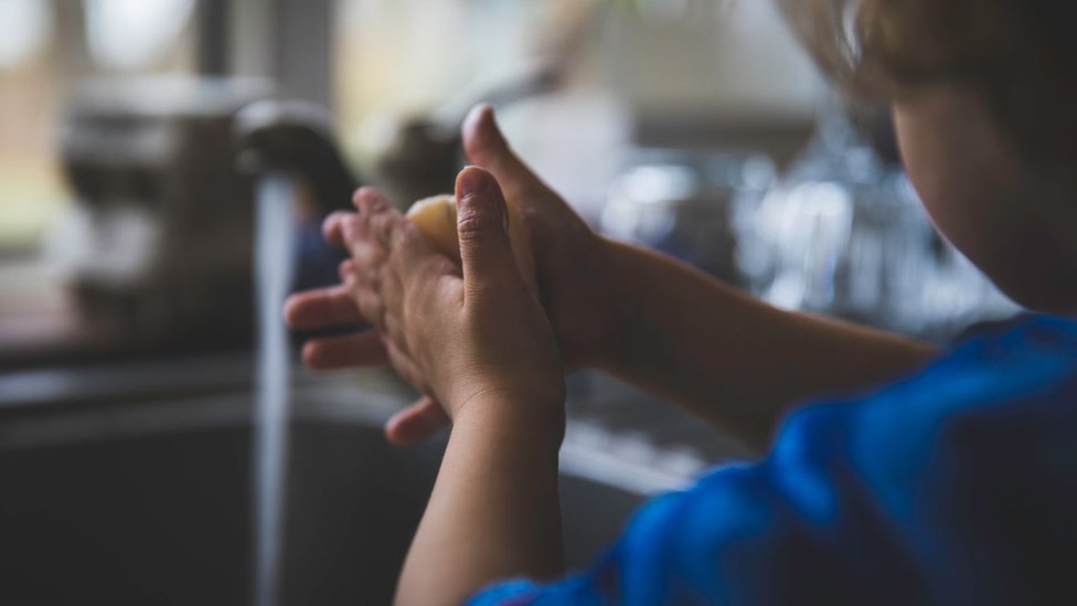 Child washing their hands