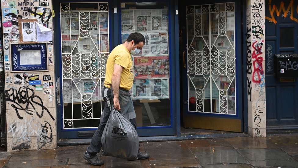Man walks past closed restaurant in Tower Hamlets, east London