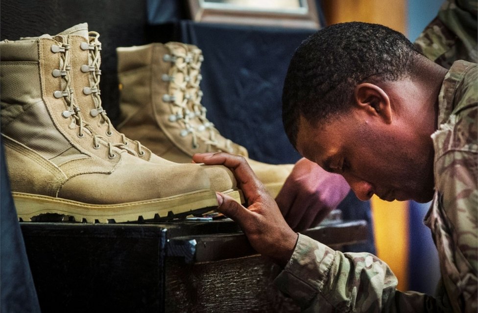 A US soldier from the 3rd Cavalry Regiment pays his respects during a memorial for Specialist Wyatt Martin and Sergeant First Class Ramon Morris at Bagram Air Field in Afghanistan, on December 23, 2014