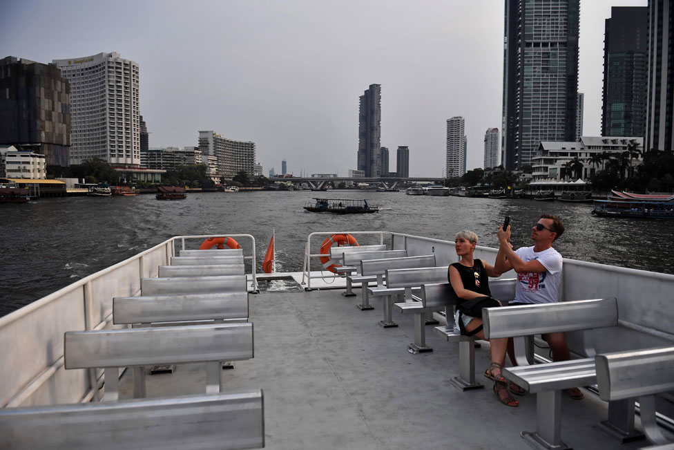 A lone couple take a tourist boat on the Chao Phraya River in Bangkok. 16 March