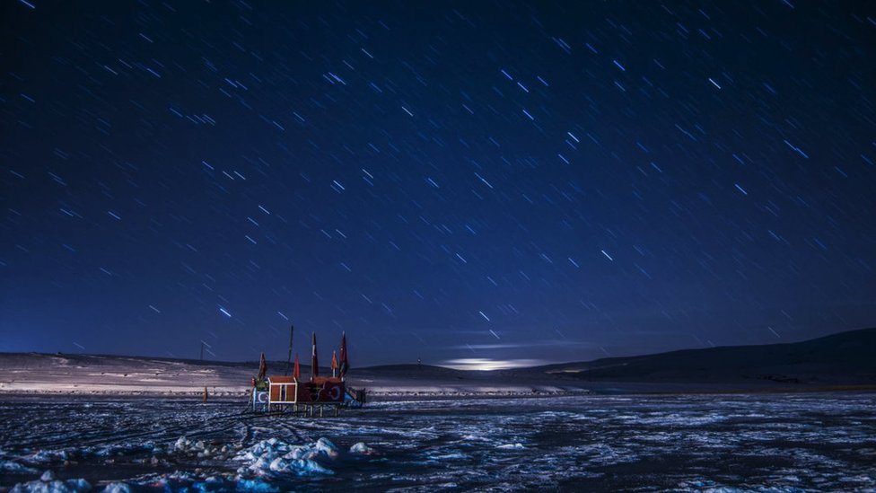 The night sky over the Lake Cildir, where parts of its surface are frozen (Kars, Turkey).