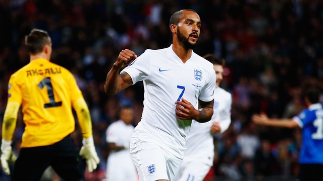 Theo Walcott celebrates scoring England's opening goal against Estonia at Wembley