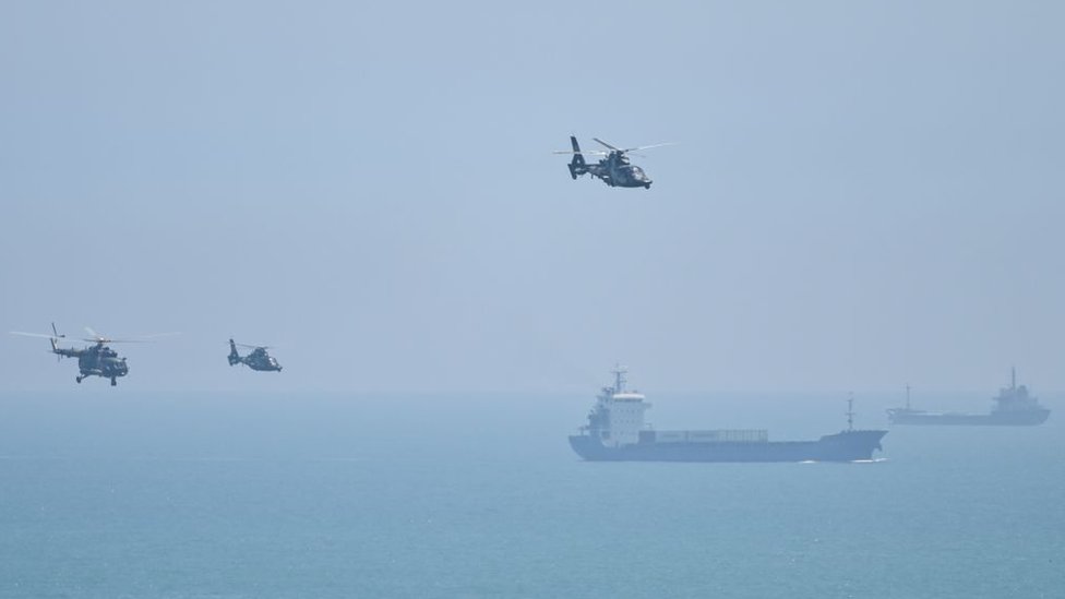 Chinese military ships and helicopters take part in the exercises in waters off the coast of Taiwan.