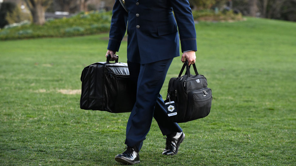 A military aide carries the presidents nuclear football