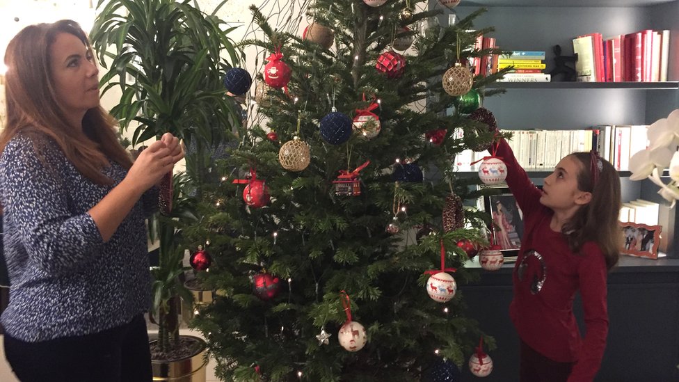 Image shows Kenza and Sofia decorating their Christmas tree