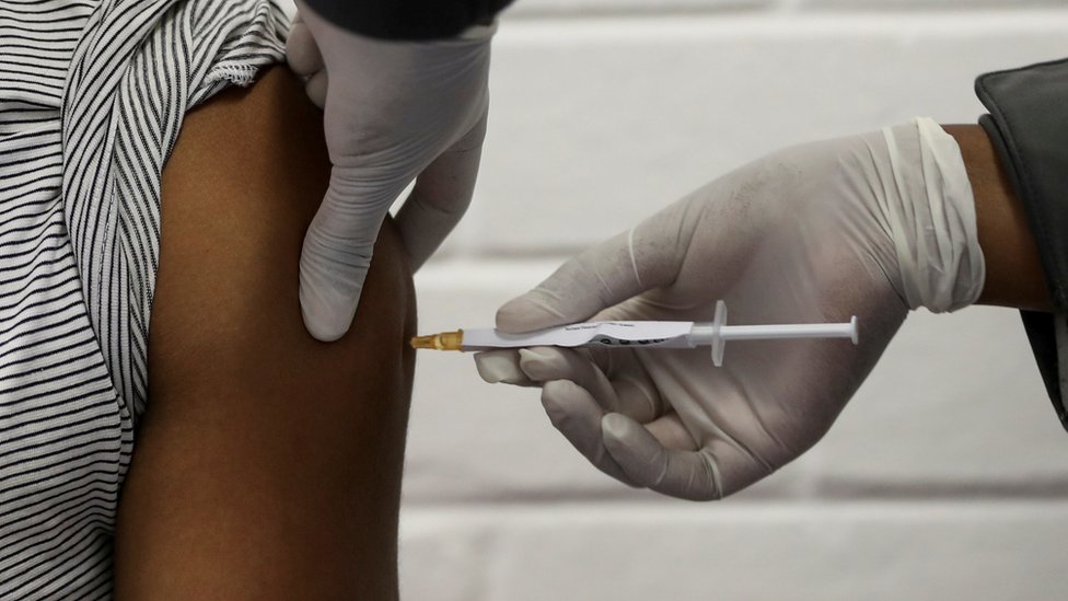 A volunteer receives an injection from a medical worker during the country's first human clinical trial for a potential vaccine against the novel coronavirus, at the Baragwanath hospital in Soweto, South Africa, June 24, 2020.