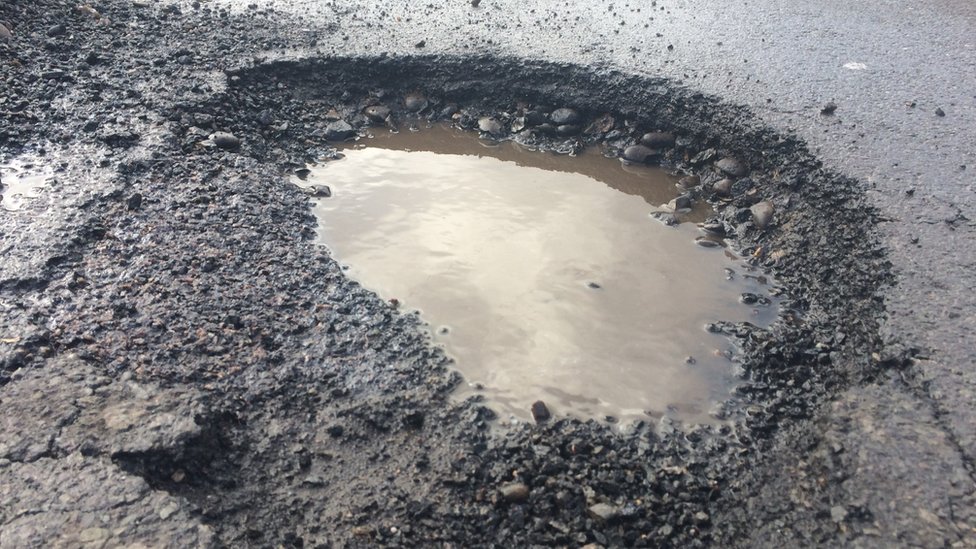 Civil engineering boss offers free pothole filling service - BBC News