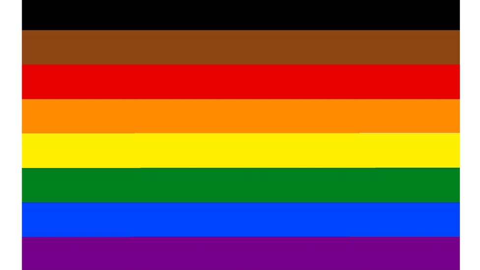 An eight-colour rainbow flag including brown and black for diversity at the top