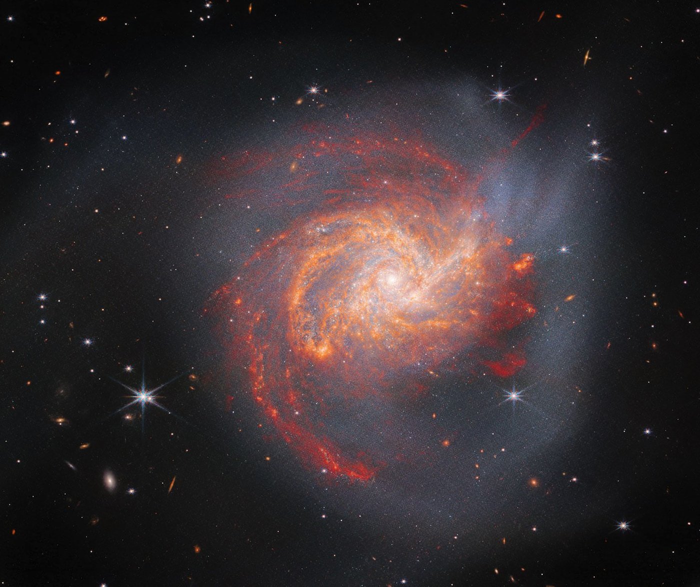 Spirals of sandy-coloured dust circle around a bright centre